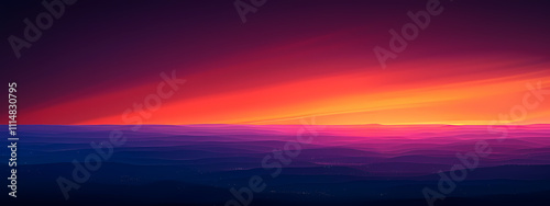 A breathtaking gradient of colors paints the horizon, showcasing vibrant orange and purple hues against deep blue mountains, creating a serene twilight ambiance.