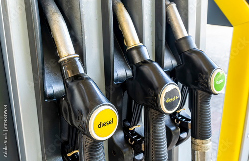 refuel station close up with three refueling dispensers of petrol and diesel on gas station. modern concept of fuel consumprion and price of fuel photo