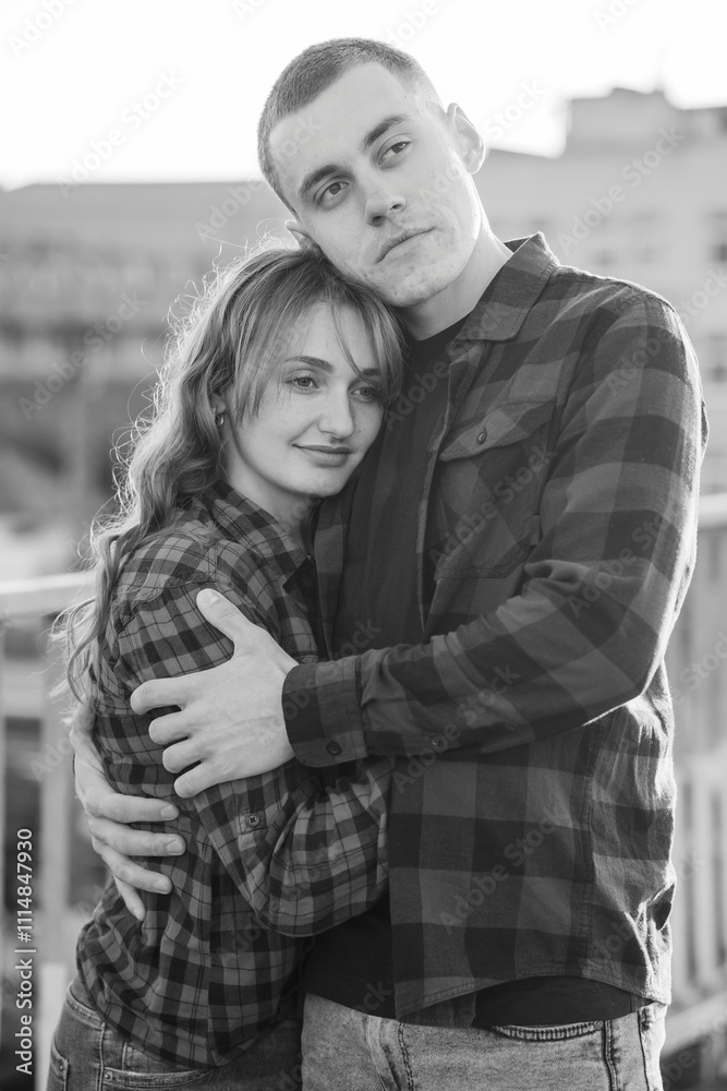 Fototapeta premium Romantic Black and White Embrace of a Young Couple in Casual Attire