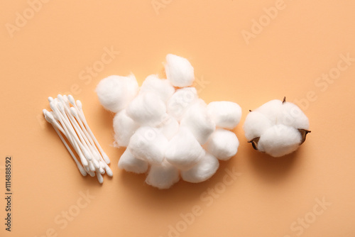 Cotton balls with swabs and flower on brown background photo