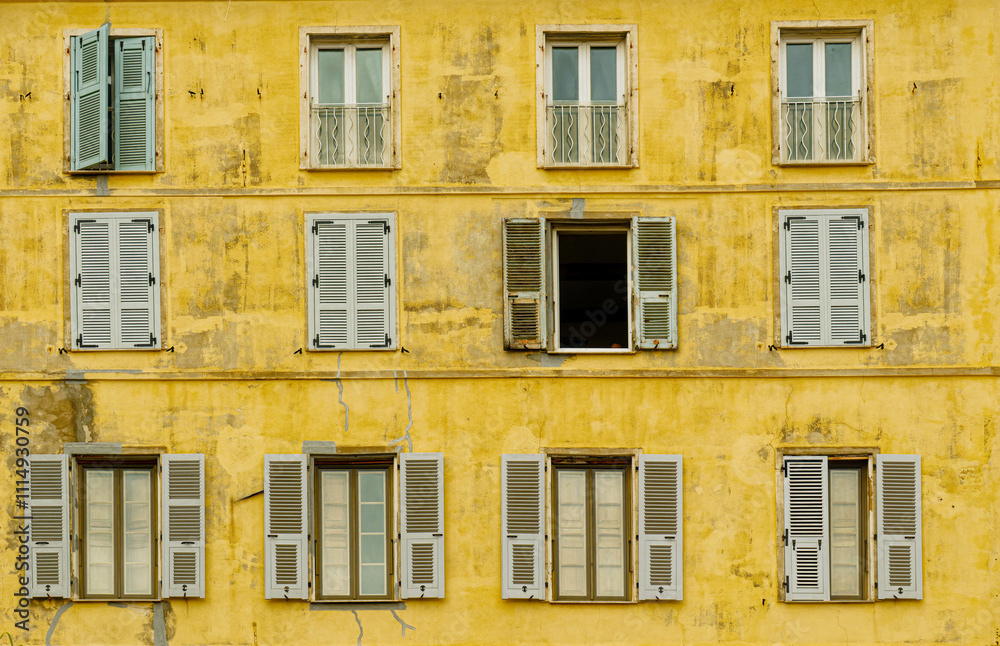 Fototapeta premium Green Shutters on Old Yellow Building