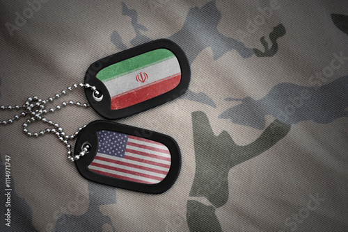 army blank, dog tag with national flag of iran and united states of america on the khaki texture background. military concept. photo