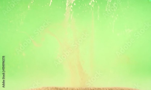 Sand Explosion Against Green Screen: A Kinetic Art Study photo