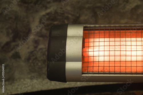 Modern electric infrared heater in living room, closeup photo