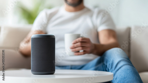 Smart speaker listening to voice commands in living room with man drinking coffee photo