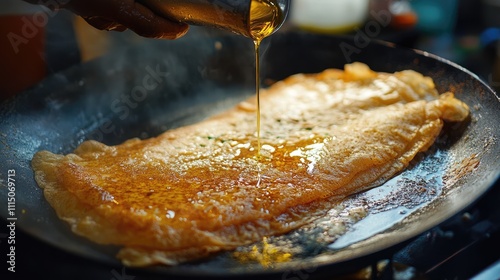 Golden Oil Drizzling Over Delicious Crispy Pancake on Hot Pan photo