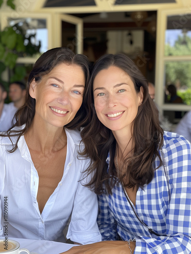 A photo of a mom and her daughter at a cafe indoors.