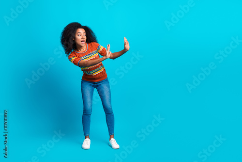 Full body length photo of dancing young relaxed american girl in stylish t shirt chill out good vibes isolated on blue color background photo