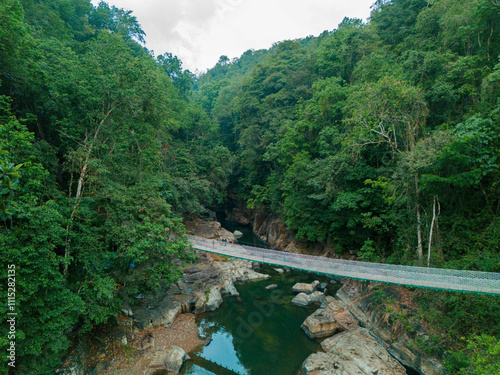 Drone view of canyon river with a hanging bridge at Cunca Wulang, West Manggarai, Indonesia photo