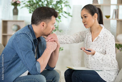 woman with clipboard consoling man