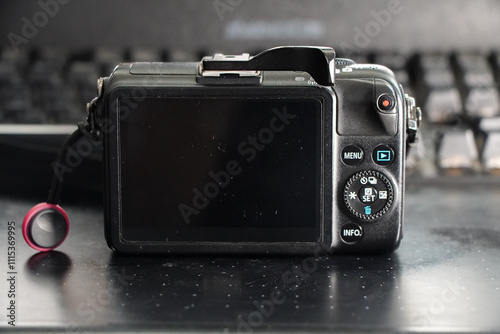 Close-up shot of a mirrorless camera, showing its screen and controls. Small and compact versatile Camera on the go. photo