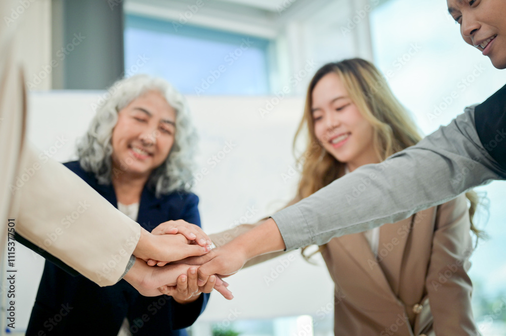 Fototapeta premium A close-up of businesspeople's hands coming together in a teamwork gesture, celebrating success.