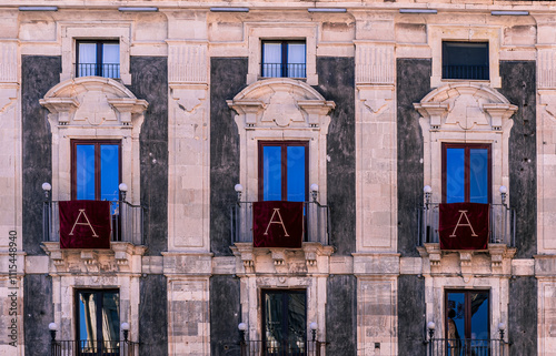 window with red banner or pennant with letter A for decotarion of old building facade photo