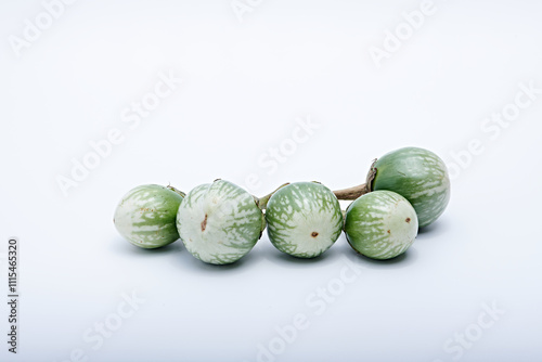 Healthy green round mini eggplant vegetable photographed with white base and background