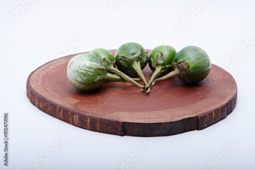 Healthy green round mini eggplant vegetable photographed with white base and background