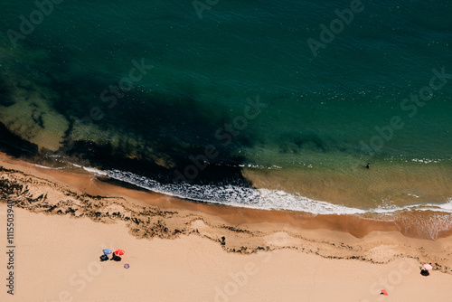 Sun bathing at the beach looking over the green ocean photo