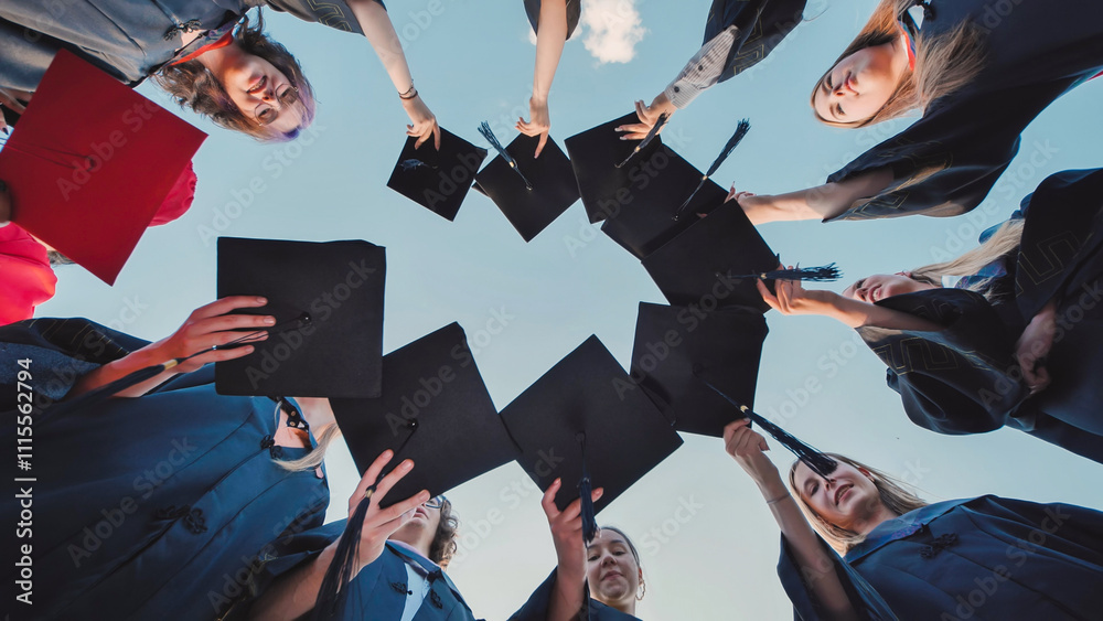 Obraz premium College graduates put their caps together and then toss them up.