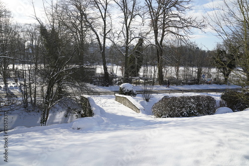 Small bridge in front of Lake Genval in winter, covered with fresh snow. photo