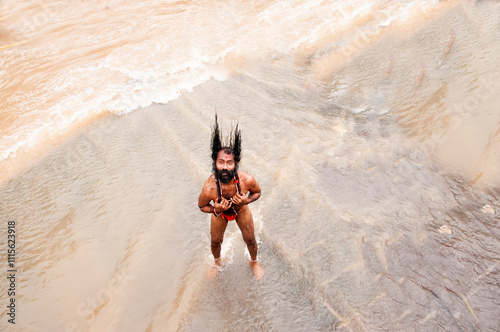 A Sadhu offering prayer in Godavari river during the Simhastha Kumbh Mela, India. photo