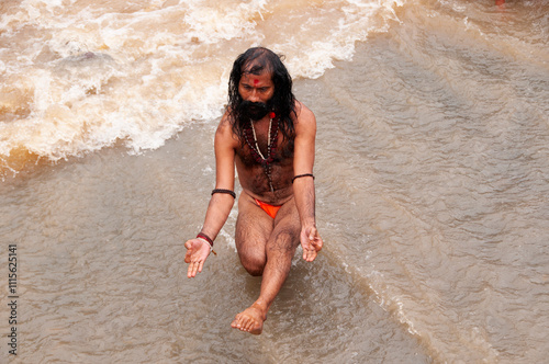 A Sadhu offering prayer in Godavari river during the Simhastha Kumbh Mela, India.