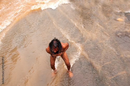 A Sadhu offering prayer in Godavari river during the Simhastha Kumbh Mela, India. photo