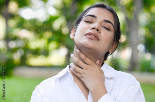 Ill, sick, unwell South Asian Indian woman having sore throat, coughing or choking with sickness, cold, flu infection with throat inflammatory infection photo