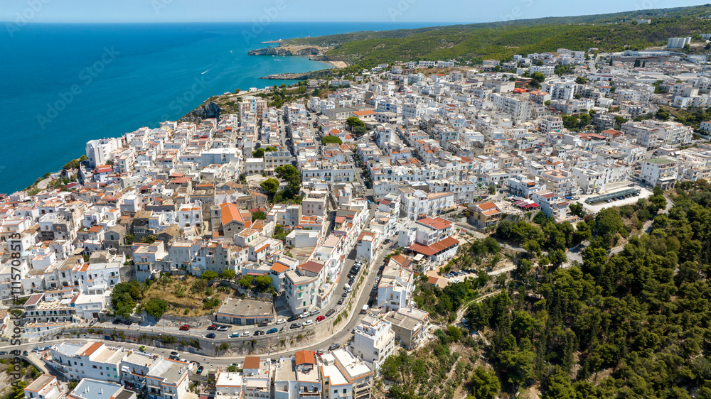 Obraz premium Aerial view of the town of Peschici, in the province of Foggia, Puglia, Italy. It is a tourist destination in Gargano overlooking the Adriatic Sea.
