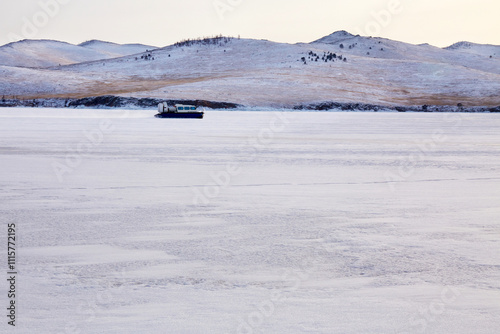 Lake Baikal in winter.A hovercraft on the ice of the frozen Lake . Kivus is a transport on ice.  photo