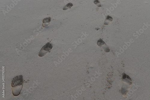Footsteps on sandy beach in Cabo Verde on autumn on gloomy day.