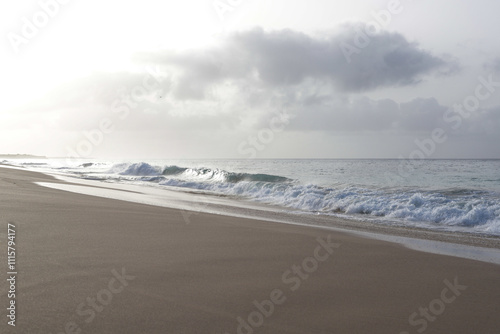 Beautiful turquoise waves of Atlantic Ocean on grey gloomy day in Cabo Verde.