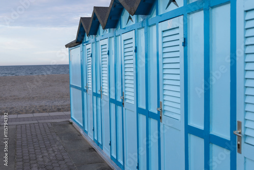 Blue changing cabins on the beach on summer.