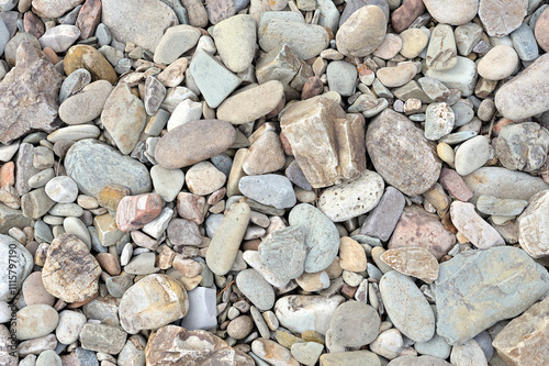 Natural Textures. A zenithal view of stones on a river bank. A close-up horizontal and zenithal photograph capturing the diversity of textures, shapes and colors of stones on a river bank, copy space.