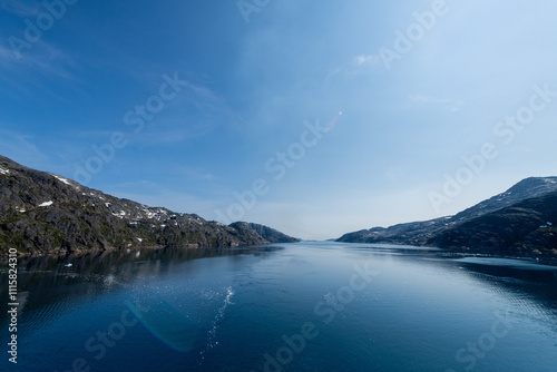 Prins Christian Sund Greenland mountain fjord with floating ice and shore iceberg on a summer day