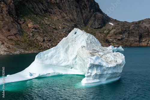 Prins Christian Sund Greenland mountain fjord with floating ice and shore iceberg on a summer day
