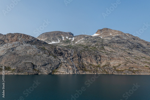 Prins Christian Sund Greenland mountain fjord with floating ice and shore iceberg on a summer day