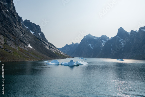 Prins Christian Sund Greenland mountain fjord with floating ice and shore iceberg on a summer day