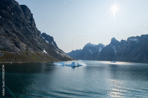 Prins Christian Sund Greenland mountain fjord with floating ice and shore iceberg on a summer day