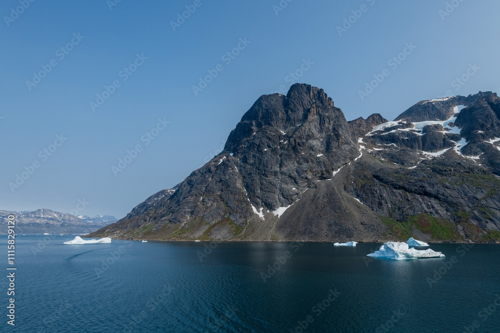 Obraz premium Prins Christian Sund Greenland mountain fjord with floating ice and shore iceberg on a summer day