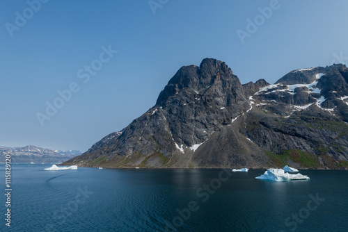 Prins Christian Sund Greenland mountain fjord with floating ice and shore iceberg on a summer day