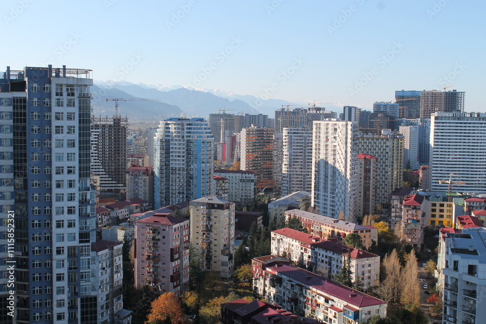 Naklejka premium Multi-level chaotic development in Batumi, Georgia, on a sunny day. The variety of architectural styles and high-rise buildings forms a unique urban landscape 