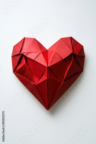 A red heart made of paper is on a white background