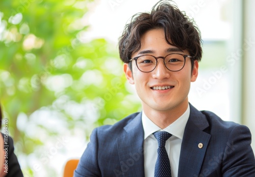 Wallpaper Mural Smartly Dressed Young Man Smiling with Glasses in Office Setting Torontodigital.ca