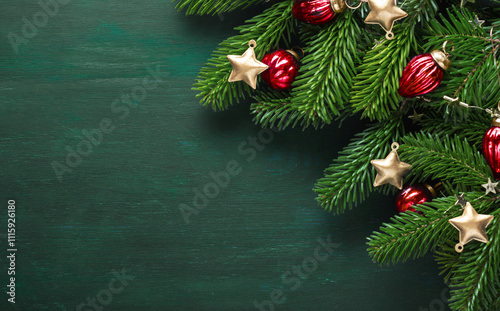 Obraz na płótnie New Year and Christmas background. Fir branch with Christmas ornaments on a dark green painted wooden background. Flat lay. w salonie