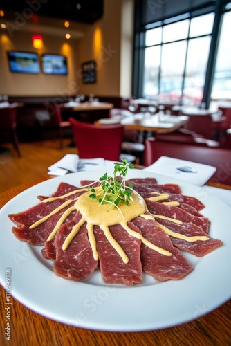  Delicado carpaccio de res servido con salsa cremosa y decorado con microgreens.
 photo