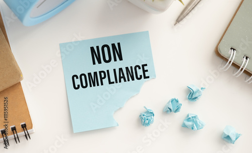 Closeup on businessman holding a card with NON COMPLIANCE message, business concept image with soft focus background photo
