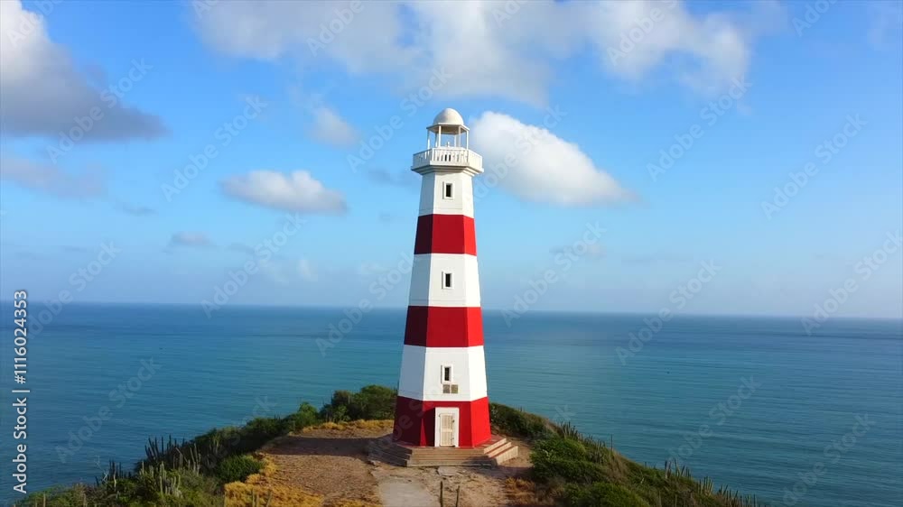 lighthouse is on a hill overlooking the ocean lighthouse is on a hill overlooking the ocean