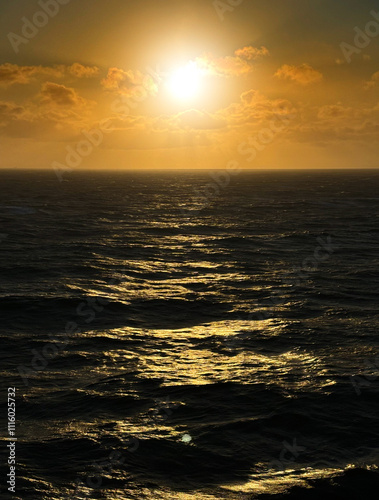 orange sunset above black sea