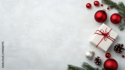 Decorative holiday arrangement with wrapped gift and festive ornaments on lig...