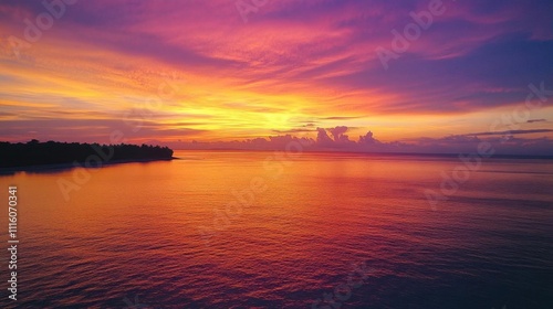 A vibrant sunset over calm waters, creating a serene atmosphere.