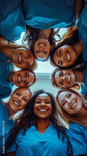 Group of healthcare professionals smiling together in blue scrubs in a bright...
